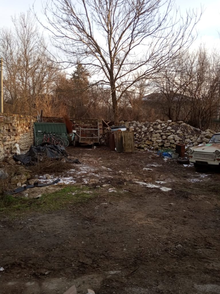 The cleared yard and pile of stones